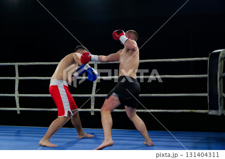 Fierce boxing match showcases athletes' power and skill. 131404311