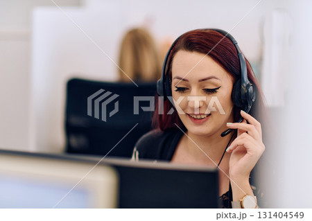 Friendly Call Center Agent Answering Incoming Calls with Headset Providing Remote Customer Service. Friendly Call Center Agent Answering Incoming Calls with Headset Providing Remote Customer Service. 131404549