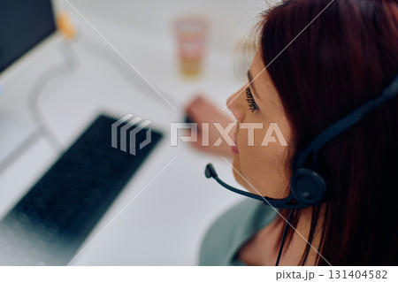 Friendly Call Center Agent Answering Incoming Calls with Headset Providing Remote Customer Service. 131404582