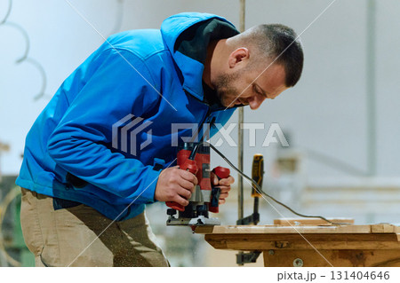 Close Up of Worker Carefully Cutting and Planing Wooden Pieces for Furniture in Wood Industry 131404646