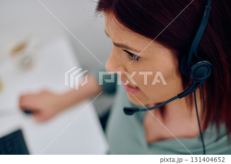 Friendly Call Center Agent Answering Incoming Calls with Headset Providing Remote Customer Service. Friendly Call Center Agent Answering Incoming Calls with Headset Providing Remote Customer Service. 131404652