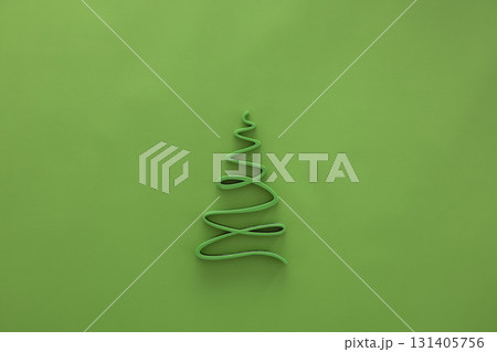 A simple green Christmas tree outline made of wire on a bright green background. The design is minimalistic and festive, suitable for holiday themes. A simple green Christmas tree outline made of wire on a bright green background. The design is minimalistic and festive, suitable for holiday themes. 131405756