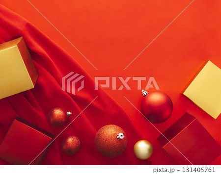 Christmas composition with red and gold gift boxes fabric and baubles on vibrant red background with wide empty copy space concept of holiday celebration seasonal banner template and festive 131405761
