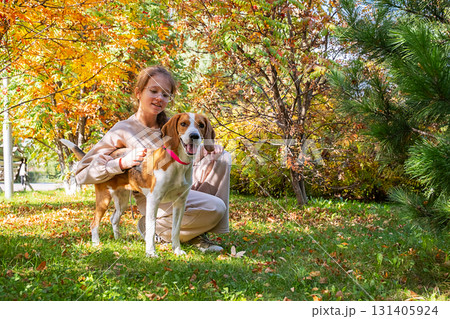 Young girl petting dog in park. Pet adoption concept. Young girl petting dog in park. Pet adoption concept. 131405924