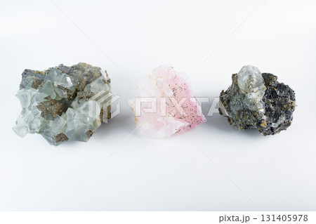 Three mineral stones together, pink manganoan calcite, cubic fluorite with pyrite, and galena lead glance, photographed on white background. Three mineral stones together, pink manganoan calcite, cubic fluorite with pyrite, and galena lead glance, photographed on white background. 131405978