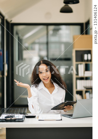 Confident business expert attractive smiling young woman holding digital tablet Confident business expert attractive smiling young woman holding digital tablet 131406124