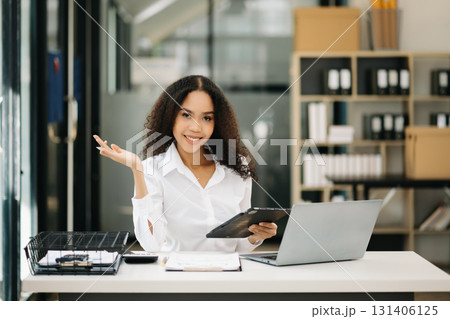 Confident business expert attractive smiling young woman holding digital tablet Confident business expert attractive smiling young woman holding digital tablet 131406125