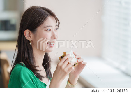 サンドイッチを食べる女性 131406173