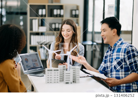 Business people with blueprints and wind turbine models and Solar Energy city Concept. 131406252