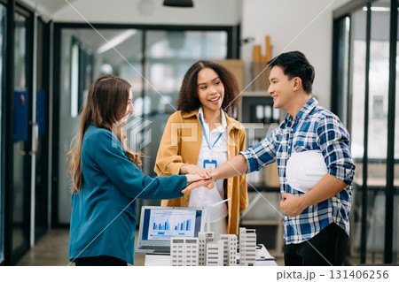 Happy businesspeople while collaborating on a new project in an office. Group of diverse businesspeople 131406256