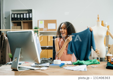 Young influencer showcasing clothing in a creative workspace, highlighting ecommerce, digital marketing Young influencer showcasing clothing in a creative workspace, highlighting ecommerce, digital marketing 131406363