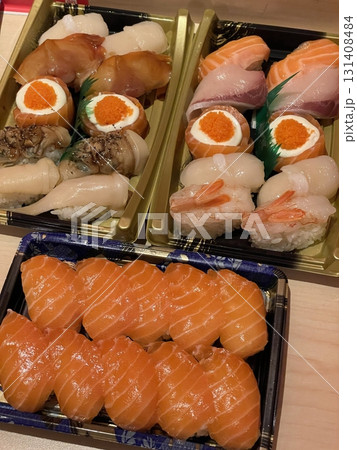 An assortment of fresh sushi, artfully arranged with a variety of toppings and vibrant colors. This traditional Japanese dish combines vinegared rice, seafood, and vegetables for an experience. An assortment of fresh sushi, artfully arranged with a variety of toppings and vibrant colors. This traditional Japanese dish combines vinegared rice, seafood, and vegetables for an experience. 131408484