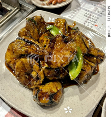 Spicy and flavorful sambal terong with tender grilled eggplant smothered in a rich, spicy chili sauce. A perfect combination of smoky, savory, and spicy flavors for a delicious side dish. Spicy and flavorful sambal terong with tender grilled eggplant smothered in a rich, spicy chili sauce. A perfect combination of smoky, savory, and spicy flavors for a delicious side dish. 131408491