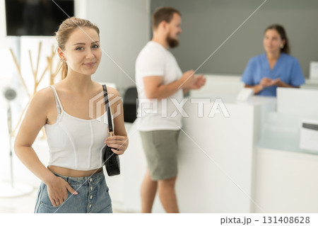 Young girl in the lobby of a modern dental clinic near reception desk 131408628