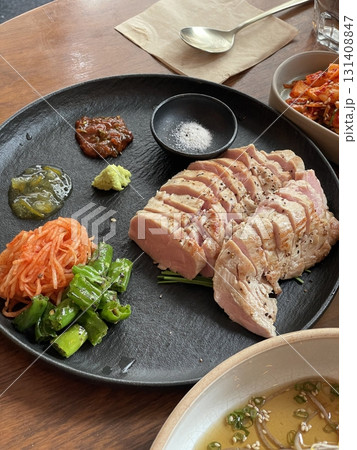 Suyuk, a traditional Korean dish of boiled pork slices, tender and juicy, often served with salted shrimp sauce, garlic, and ssamjang. Perfect for wrapping in lettuce for a flavorful, balanced bite. Suyuk, a traditional Korean dish of boiled pork slices, tender and juicy, often served with salted shrimp sauce, garlic, and ssamjang. Perfect for wrapping in lettuce for a flavorful, balanced bite. 131408847