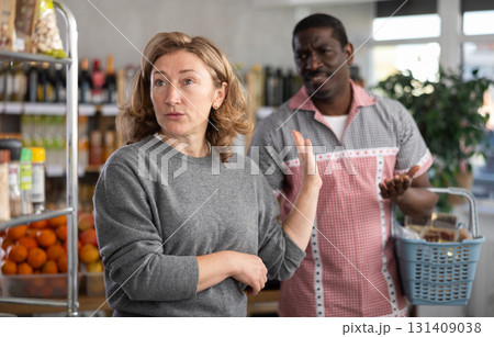 European wife and African husband, yells at each other in shop 131409038