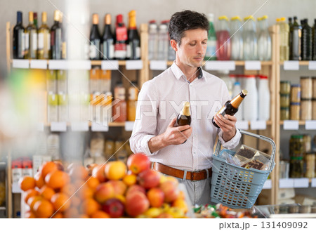 Adult man choosing beer in grocery store 131409092