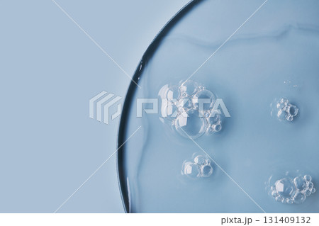 Close-up of bubbles in transparent gel on light blue background 131409132