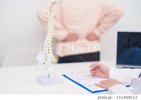 Elderly Patient consulting Doctor with Spine anatomy for Spinal Cord Disorder and disease, Back pain, Lumbar, Sacral pelvis, Cervical neck, Thoracic, Coccyx, Orthopedist, chiropractic, Office Syndrome Elderly Patient consulting Doctor with Spine anatomy for Spinal Cord Disorder and disease, Back pain, Lumbar, Sacral pelvis, Cervical neck, Thoracic, Coccyx, Orthopedist, chiropractic, Office Syndrome 131409212