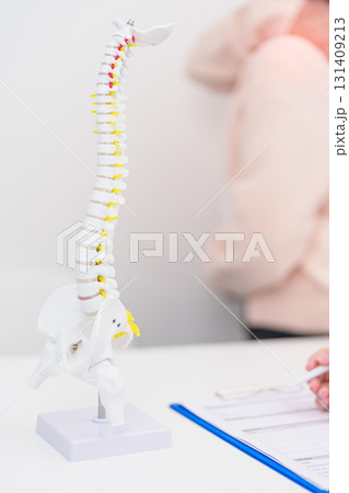 Elderly Patient consulting Doctor with Spine anatomy for Spinal Cord Disorder and disease, Back pain, Lumbar, Sacral pelvis, Cervical neck, Thoracic, Coccyx, Orthopedist, chiropractic, Office Syndrome Elderly Patient consulting Doctor with Spine anatomy for Spinal Cord Disorder and disease, Back pain, Lumbar, Sacral pelvis, Cervical neck, Thoracic, Coccyx, Orthopedist, chiropractic, Office Syndrome 131409213