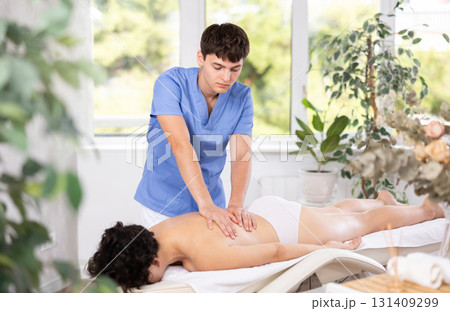 Relaxing professional massage for woman in spa salon Relaxing professional massage for woman in spa salon 131409299