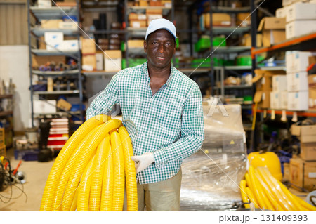 Portrait of focused African American man buying hoses 131409393