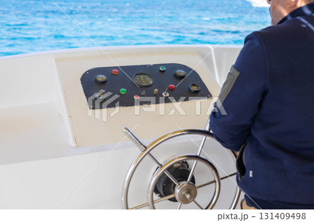 Captivating maritime journey with sailor steering boat in open sea 131409498