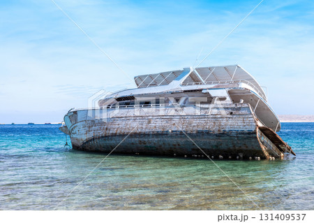 Abandoned shipwreck in clear blue ocean water under bright sky 131409537