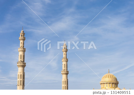 Majestic mosque minarets and dome against clear blue sky for architectural inspiration 131409551