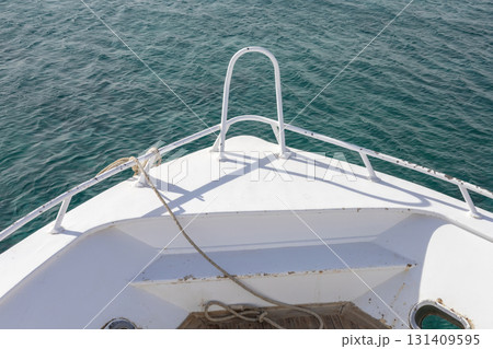 Serene view from a boat bow overlooking calm ocean waters for nautical themes 131409595