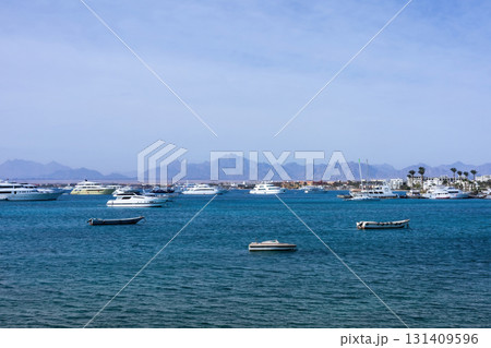 Serene seascape with boats and yachts on a tranquil blue ocean 131409596