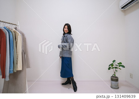 グレーのジャケットとブルーのスカートのコーディネートを紹介するファッション系インフルエンサー グレーのジャケットとブルーのスカートのコーディネートを紹介するファッション系インフルエンサー 131409639