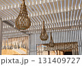 Rustic outdoor patio with woven lanterns under a slatted pergola for a cozy atmosphere 131409727