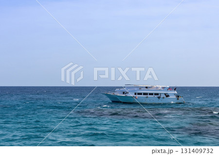 Tranquil ocean scene with sailboat in open sea as summer vacation inspiration Tranquil ocean scene with sailboat in open sea as summer vacation inspiration 131409732