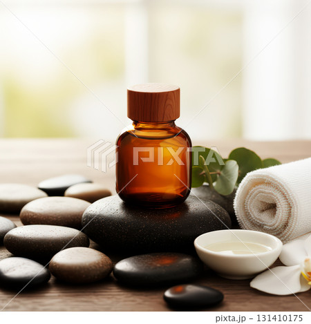Amber glass bottle with spa stones and towel 131410175