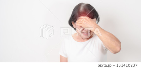 Elderly Woman having headache and Dizzy for concepts of Chronic Stress, Headache and Migraine, World Brain Tumor day, Brain Cancer, Brain Stroke, Dementia, alzheimer, Hypotension and mental health 131410237