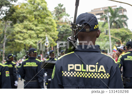 Police officer from behind with rifle, Armed policeman rear view, Law enforcement carrying firearm on back Police officer from behind with rifle, Armed policeman rear view, Law enforcement carrying firearm on back 131410298