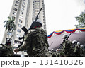 Armed soldiers in the streets of Cali, Military patrolling urban area in Colombia, Armed forces in public security operation 131410326