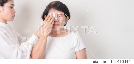 Elderly Woman with Eye protecting by Eye Pad for concepts of Eye disease, Cataract, Glaucoma, Age Related Macular Degeneration, Diabetic Retinopathy, Vitreous, Conjunctivitis, World Glaucoma day 131410344