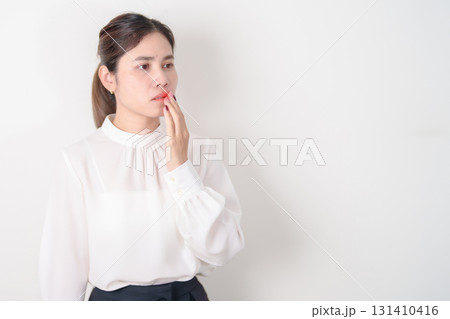 Business woman having Mouth ache for concepts of Mouth Ulcer Sore, Aphthous Stomatitis, Oral Lesions, Halitosis, Oral Health Care, Toothache and Gum Disease, Dental Caries, Gingivitis and Periodontal Business woman having Mouth ache for concepts of Mouth Ulcer Sore, Aphthous Stomatitis, Oral Lesions, Halitosis, Oral Health Care, Toothache and Gum Disease, Dental Caries, Gingivitis and Periodontal 131410416