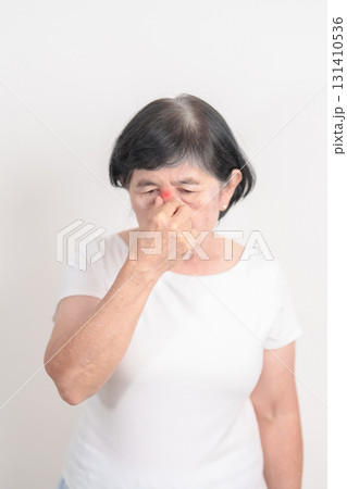 Elderly Woman having Nose pain for concepts of Nose disease, Common Cold, Influenza, Flu, Covid 19, Respiratory Infection, Sinusitis, Allergic Rhinitis, Asthma, Allergy, Dry nose Anosmia and Health Elderly Woman having Nose pain for concepts of Nose disease, Common Cold, Influenza, Flu, Covid 19, Respiratory Infection, Sinusitis, Allergic Rhinitis, Asthma, Allergy, Dry nose Anosmia and Health 131410536