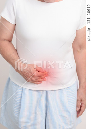 Elderly woman having Colon pain for Colonic disease, Inflammatory Bowel, IBD, Colorectal cancer, Ulcerative colitis, Diverticulitis, Irritable bowel syndrome, Digestive system and Health concept 131410619