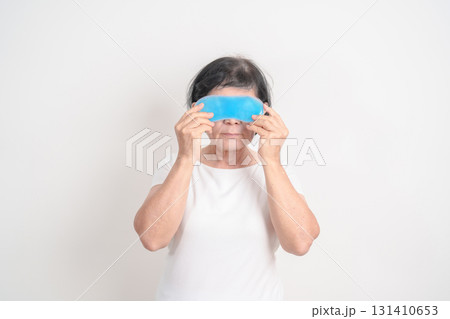 Elderly Woman with cold Eye Mask for concepts of Eye disease, Dry, Pain and Irritation eyes, Cataract, Glaucoma, Age Related Macular Degeneration, Conjunctivitis, World Glaucoma day and health Elderly Woman with cold Eye Mask for concepts of Eye disease, Dry, Pain and Irritation eyes, Cataract, Glaucoma, Age Related Macular Degeneration, Conjunctivitis, World Glaucoma day and health 131410653