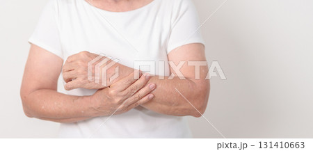 Elderly Woman having wrist pain with Medicated pain relief patch plaster for Carpal Tunnel Syndrome, Wrist Tendinitis, muscle ache, De Quervain s tenosynovitis, Hand Osteoarthritis and Senior health Elderly Woman having wrist pain with Medicated pain relief patch plaster for Carpal Tunnel Syndrome, Wrist Tendinitis, muscle ache, De Quervain s tenosynovitis, Hand Osteoarthritis and Senior health 131410663