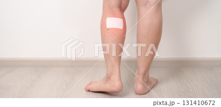 Elderly woman having Calf pain with Medicated pain relief patch plaster for concepts of Calf Muscle Strain, muscle pull, Leg Cramp, Sprain, aches, Varicose Veins, Deep Vein and world Thrombosis day 131410672
