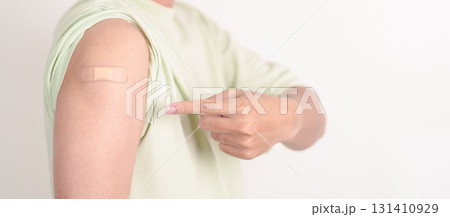 Adult Man with bandage after received vaccine. Vaccination and Immunization for Influenza, HPV, Zoster, IPD, DTP or Diphtheria, Tetanus and Pertussis, MMR, Hepatitis B, Covid and Varicella vaccine 131410929