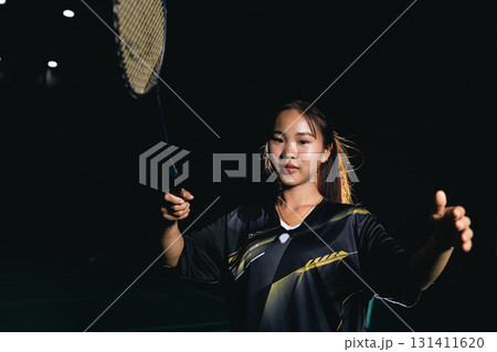 Young woman teen girl enjoy playing badminton handle racket, indoor shuttlecock sport game Young woman teen girl enjoy playing badminton handle racket, indoor shuttlecock sport game 131411620