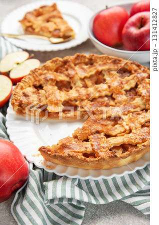Homemade apple pie with a slice and fresh apples 131412827