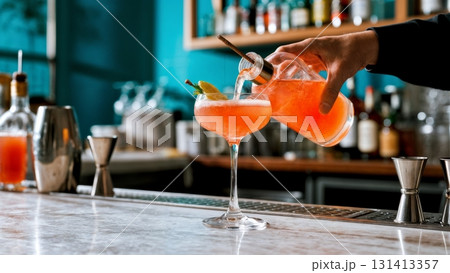 A vibrant, colorful cocktail being poured into a glass. Mixology, creative cocktails, bartender, party, celebration A vibrant, colorful cocktail being poured into a glass. Mixology, creative cocktails, bartender, party, celebration 131413357
