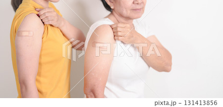 Adult and Elderly Woman with bandage after received vaccine. Vaccination and Immunization for Influenza, HPV, Zoster, IPD, DTP, Dengue, Encephalitis, Rabies, Pneumococcal Hepatitis B and Covid vaccine 131413856